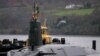 FILE PHOTO: Crew from HMS Vengeance stand on their vessel as they return along the Clyde river to the Faslane naval base near Glasgow