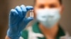 University Hospital in Coventry - A nurse holds a phial of the Pfizer/BioNTech COVID-19 vaccine