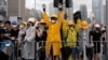 CHINA -- Protesters react to police warning as they attempt to block a ceremony in Hong Kong on Monday, July 1, 2019. 